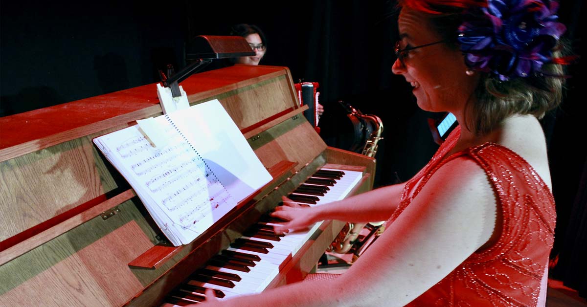 [image: Katie Coleman playing piano during Cabaret]